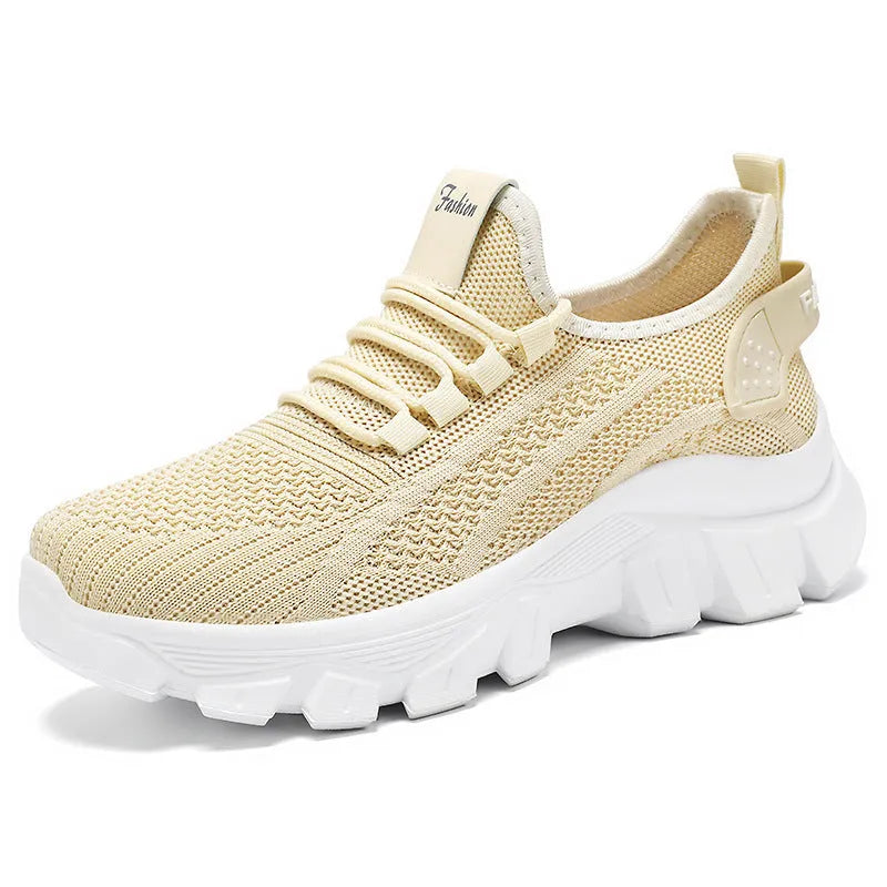 Men's white Flyknit sneakers with a thick PVC sole and round toe on a plain background.