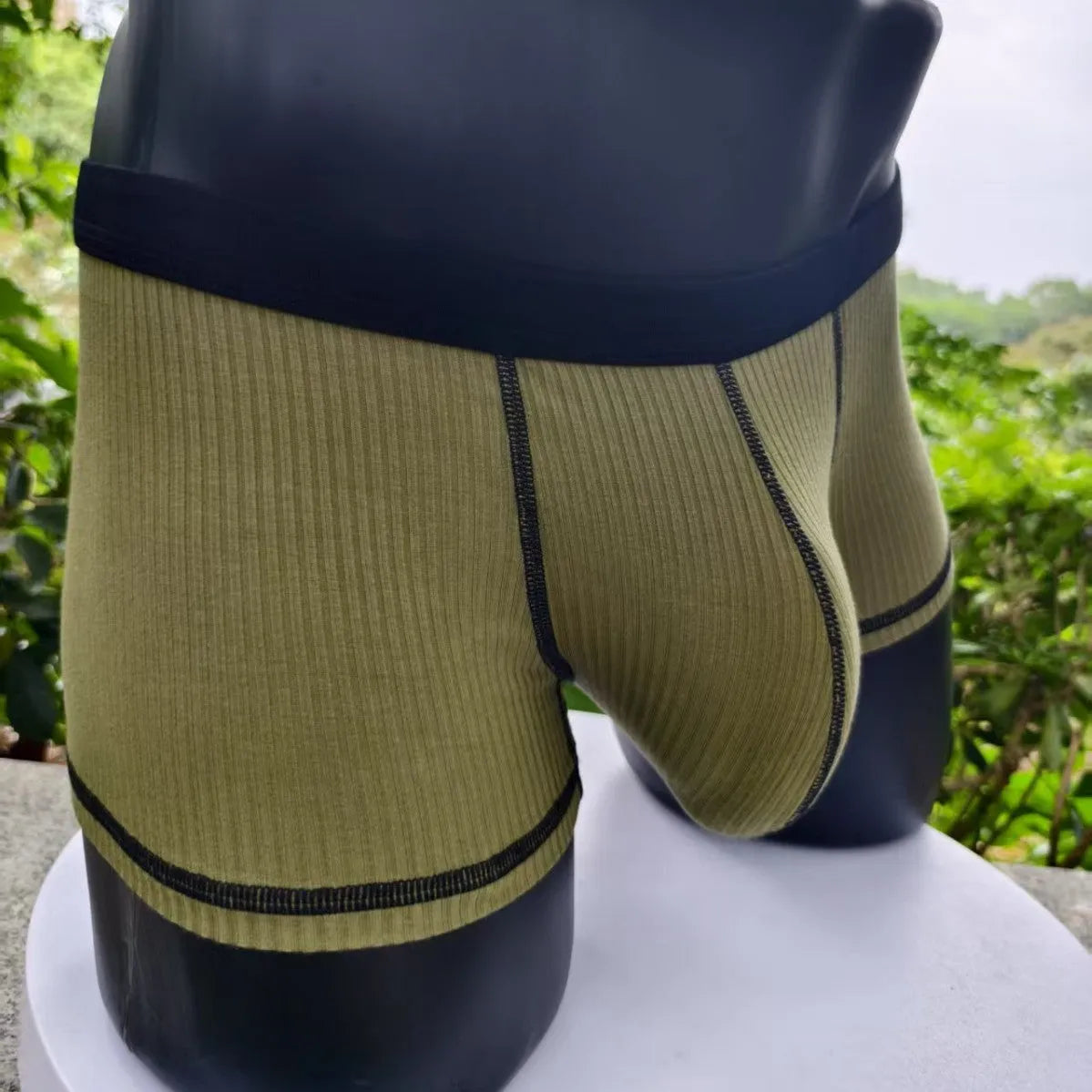 Men's solid colour boxers in breathable fibre fabric showing hip-lifting design