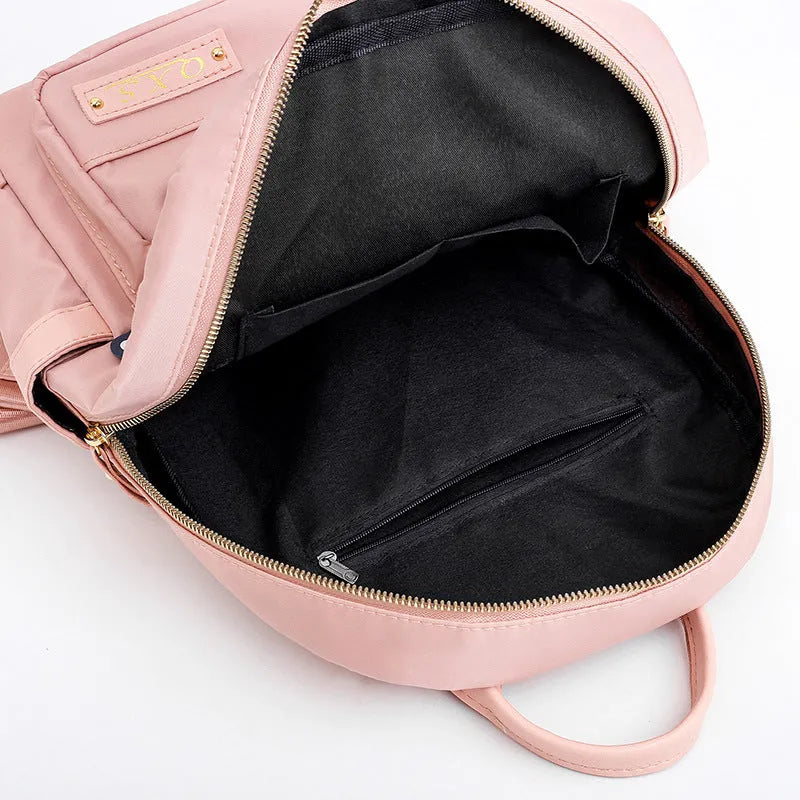 Women's black nylon casual backpack with double shoulder straps showing three-dimensional outer pockets