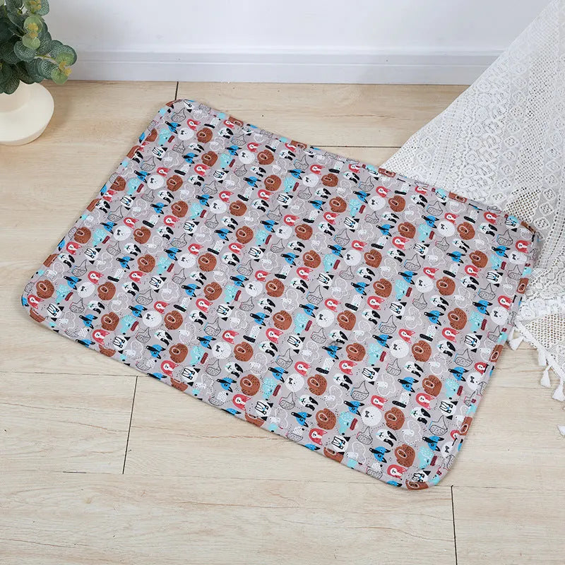 Reusable washable pet urine pad with colourful animal print and waterproof non-slip backing.
