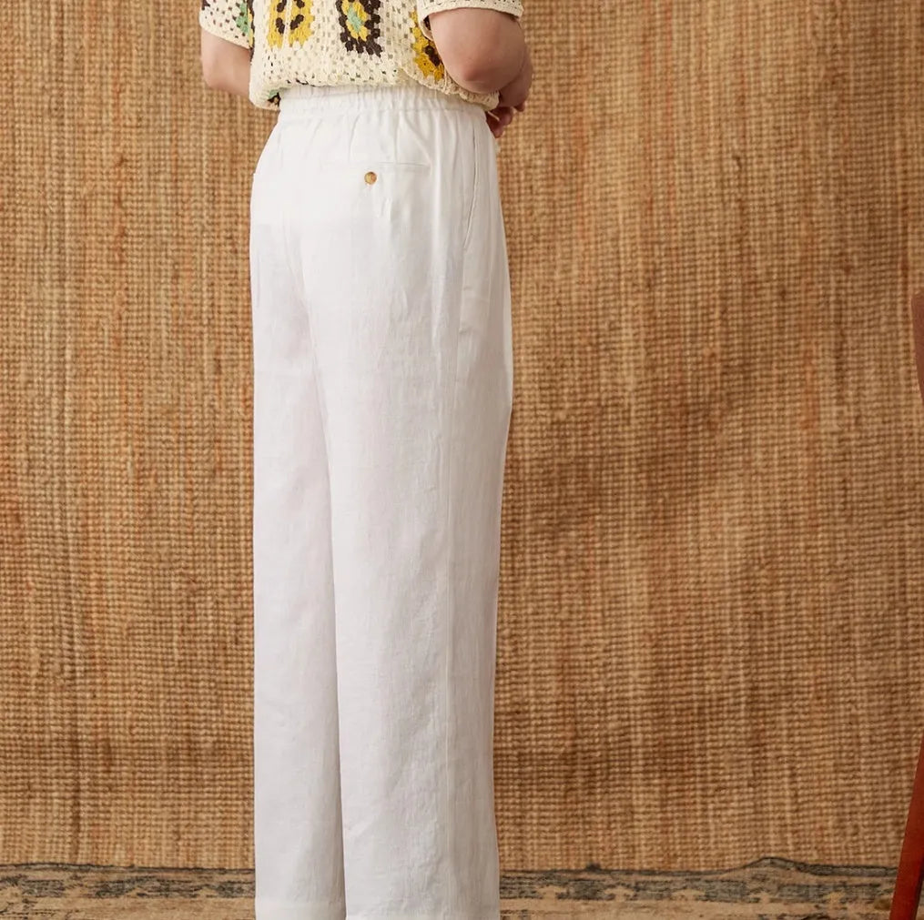 Women's linen high-waist trousers with elasticated waistband in navy blue, white, and greige colours
