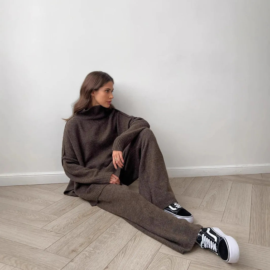 Women's dark grey side-slit sweater and trousers suit set on a hanger