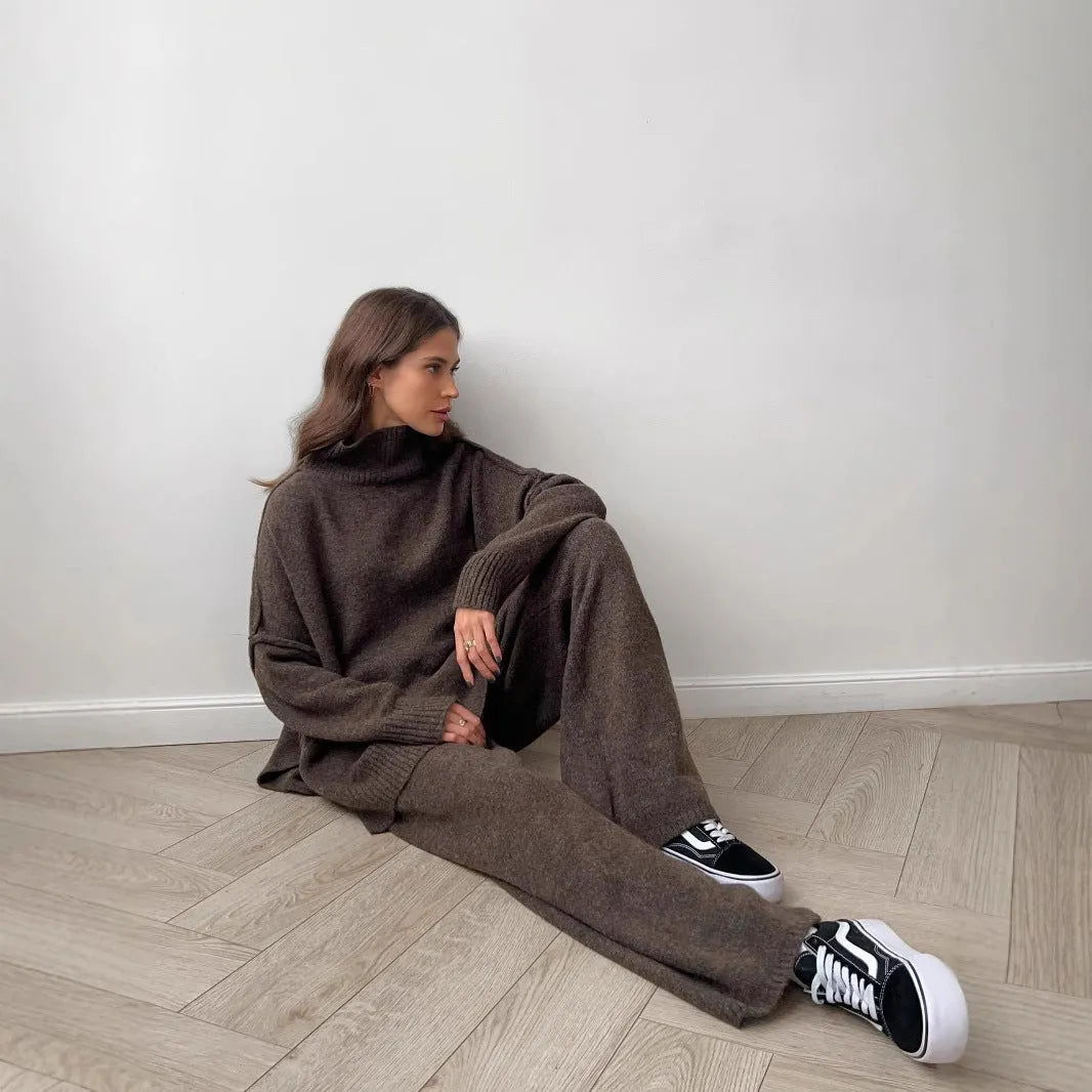Women's dark grey side-slit sweater and trousers suit set on a hanger