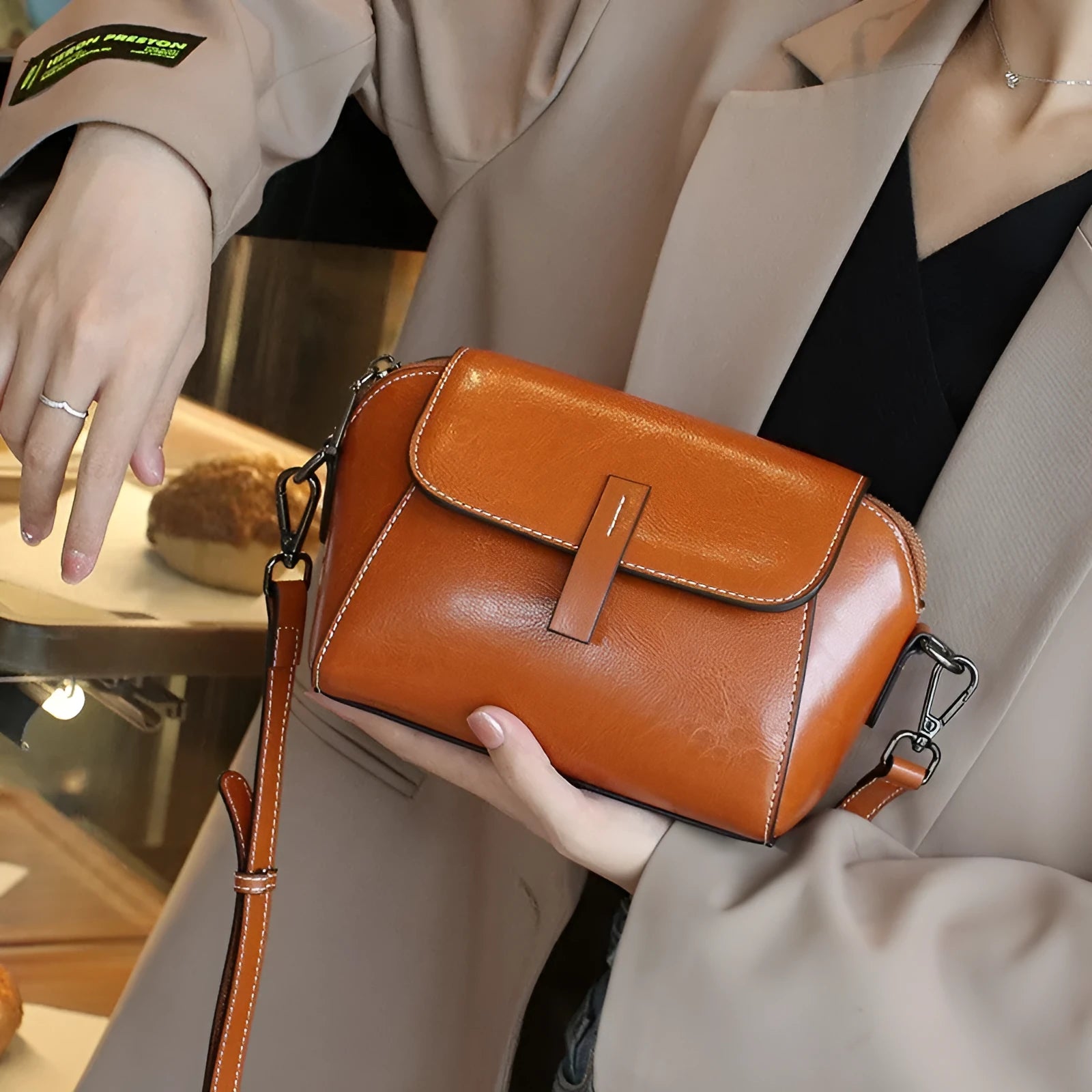 Women's brown oil wax leather messenger bag with crossbody strap and multiple internal pockets