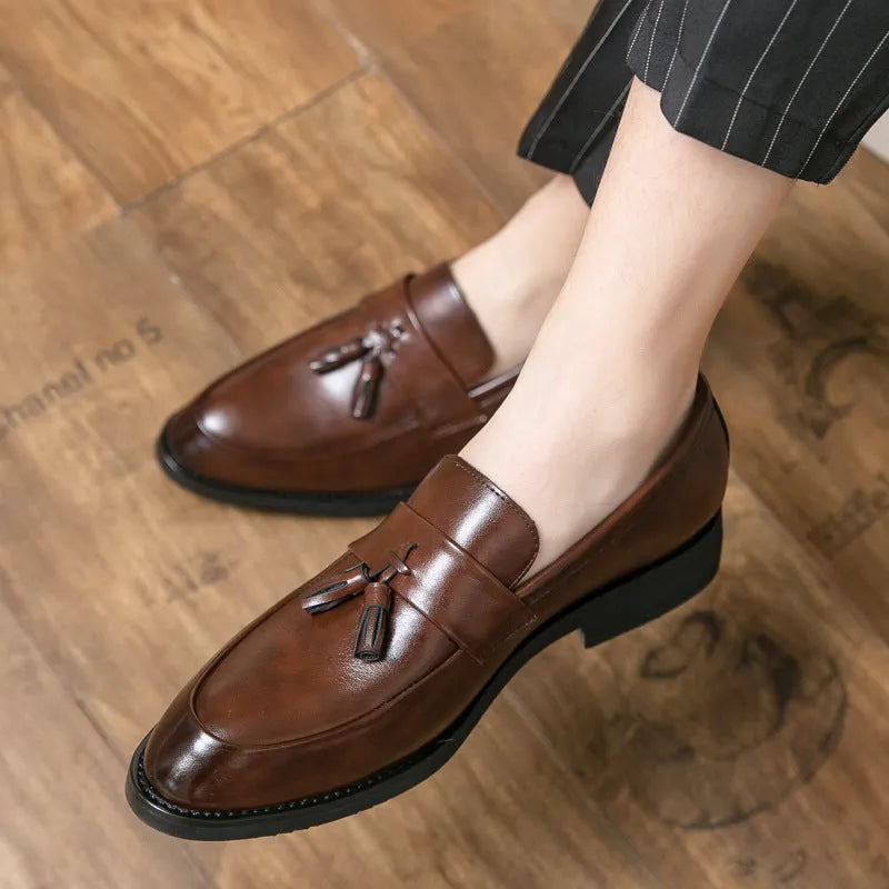 Men's black slip-on business shoes with tassel detail on artificial leather upper