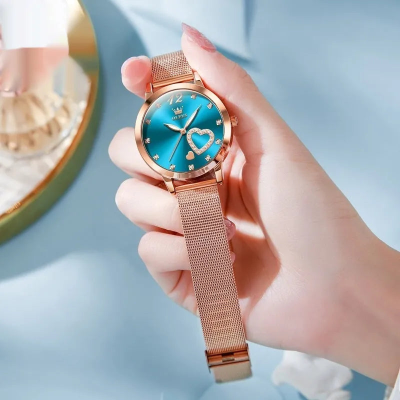Women's fashion watch with rose gold mesh strap showing six dial colour options: white, black, blue, red, pink, green.
