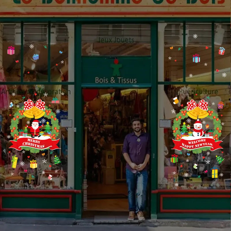 Two large colourful cartoon Christmas static cling stickers on a glass window.