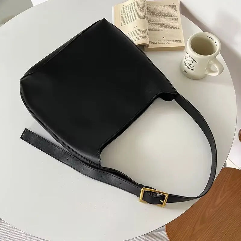 Women's soft PU shoulder bag with swing thread detailing in black ribbon or brown colour options