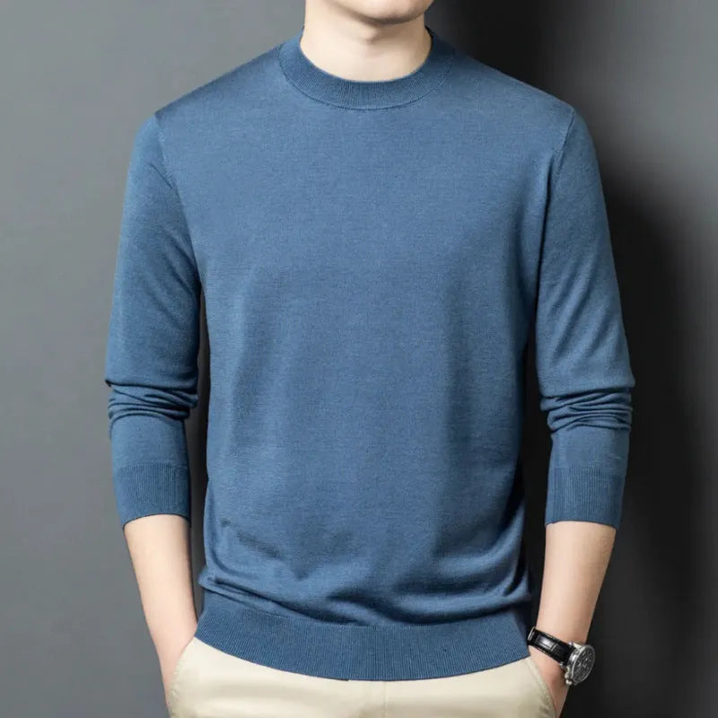 Men's round neck wool pullover sweater in a neutral colour with long sleeves, laid flat.