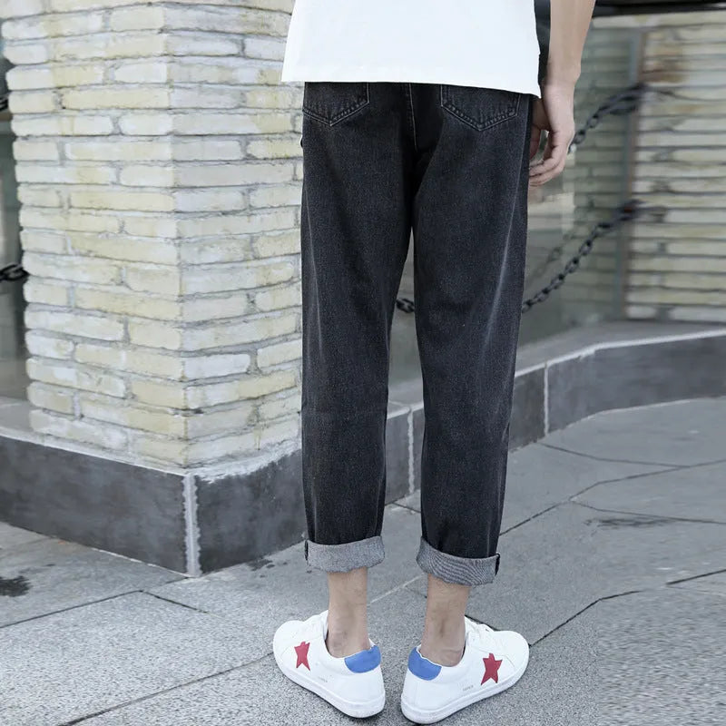 Men's loose straight leg blue cotton jeans with a college style on a casual background.