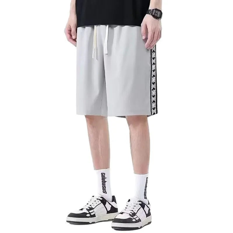 Men's loose fit track pants in black colour with elastic waistband and baggy leg cut