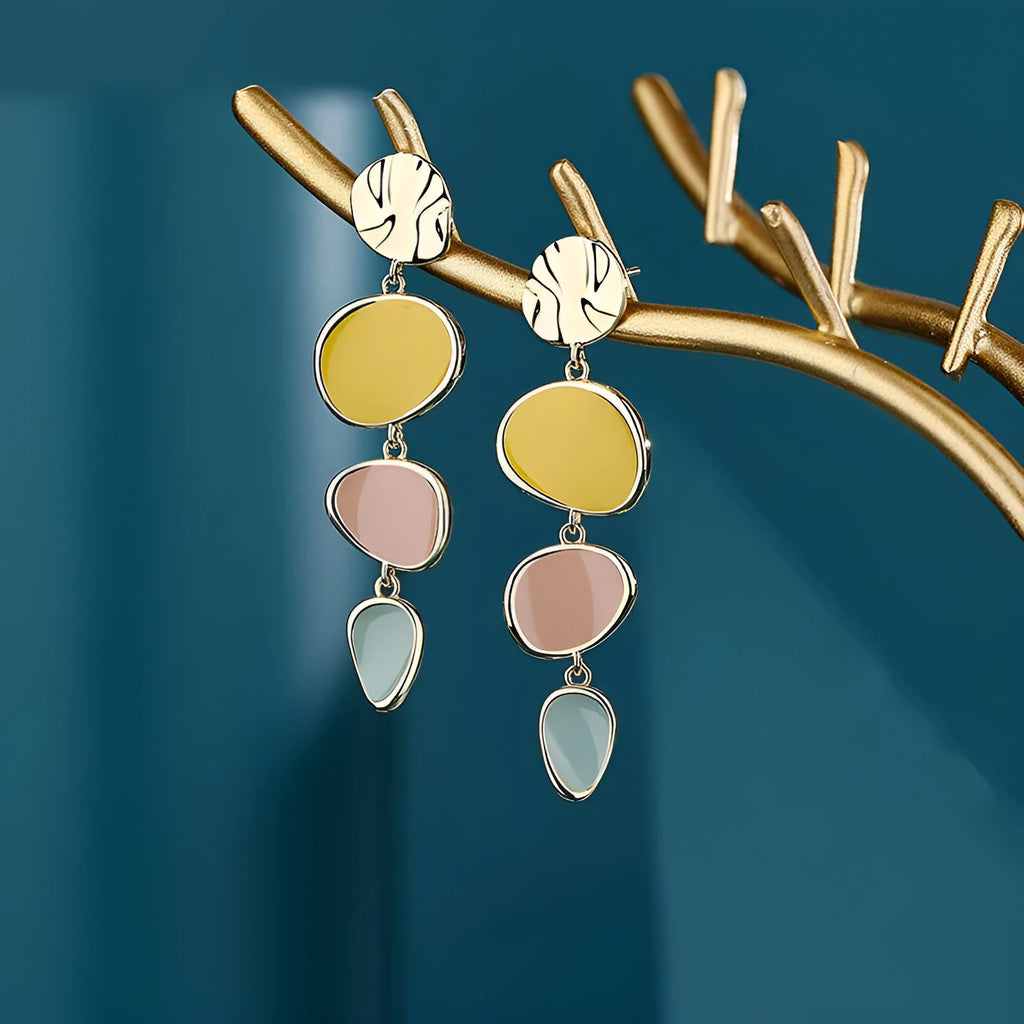 A pair of disc-shaped alloy earrings with a Morandi three-colour dripping oil finish on a sterling silver needle post.