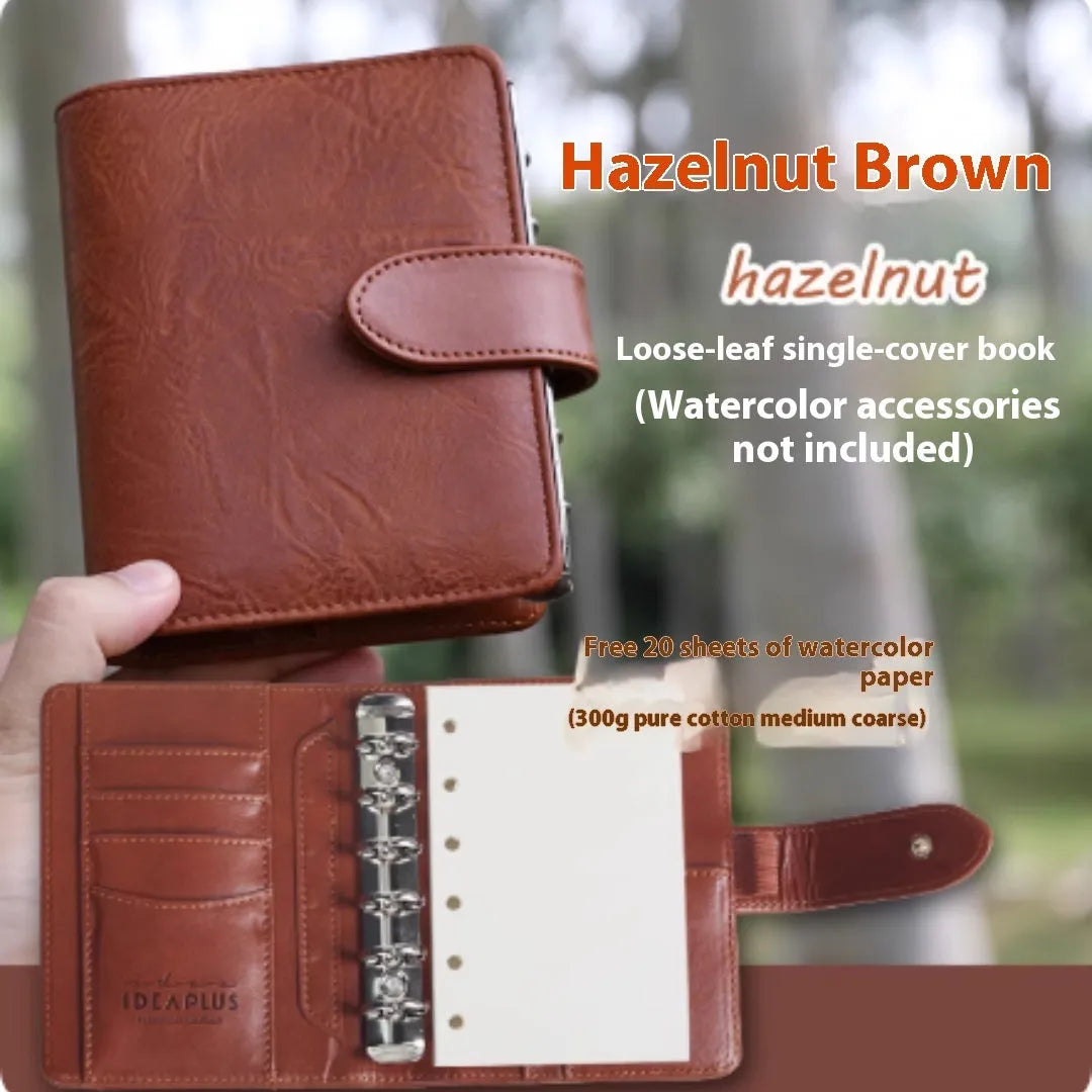 A7 format loose-leaf watercolour book in avocado green, open to show painting pages