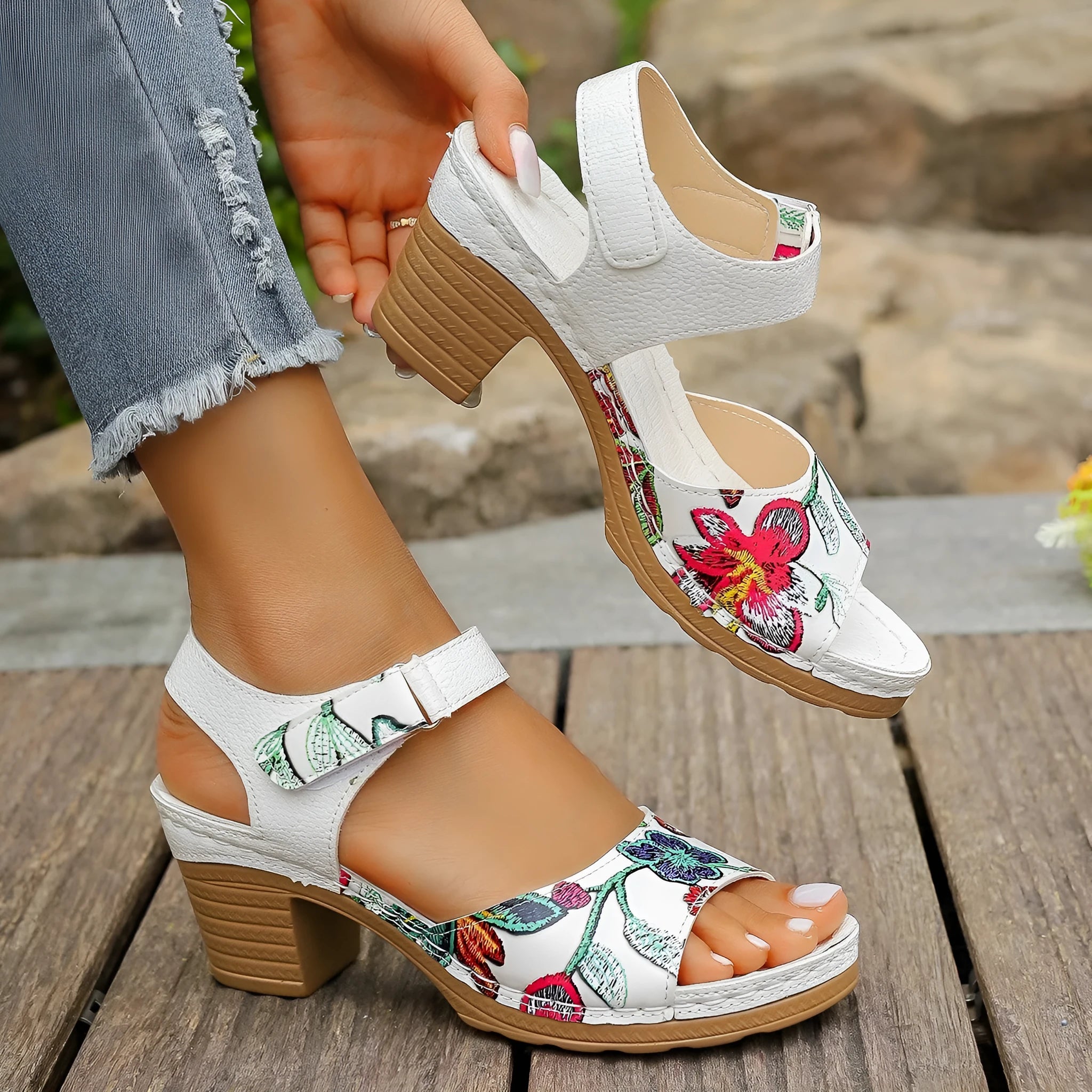 White women's high heel sandals showing the velcro buckle fastening on the strap.