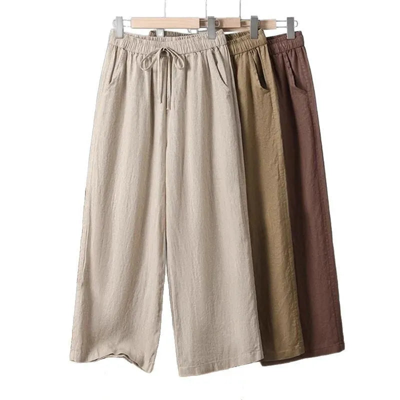 Women's straight-leg casual trousers in apricot colour with elastic and lace-up drawstring waistband.