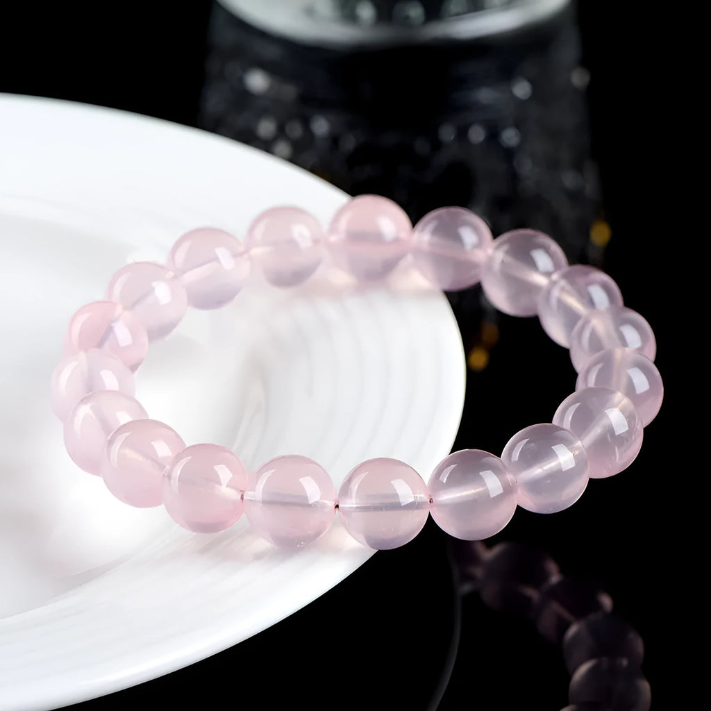 Women's polished crystal round bead bracelet in pink, showing single circle design with various size options.