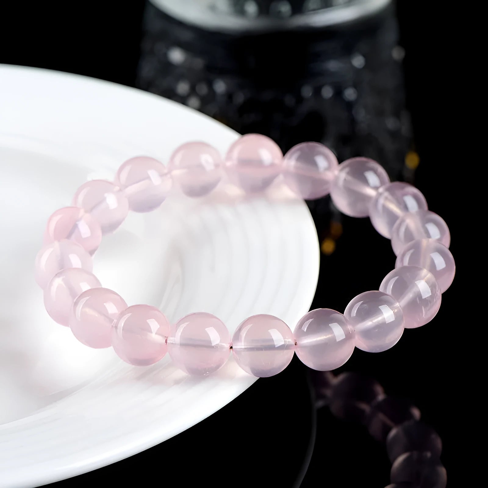 Women's polished crystal round bead bracelet in pink, showing single circle design with various size options.