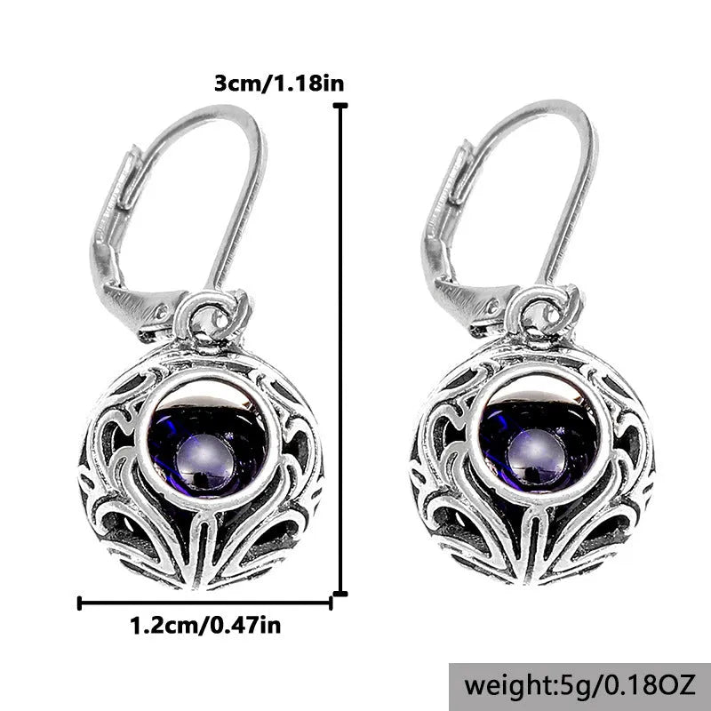 Vintage geometric silver tone pendant earrings with hollow blue gemstone setting