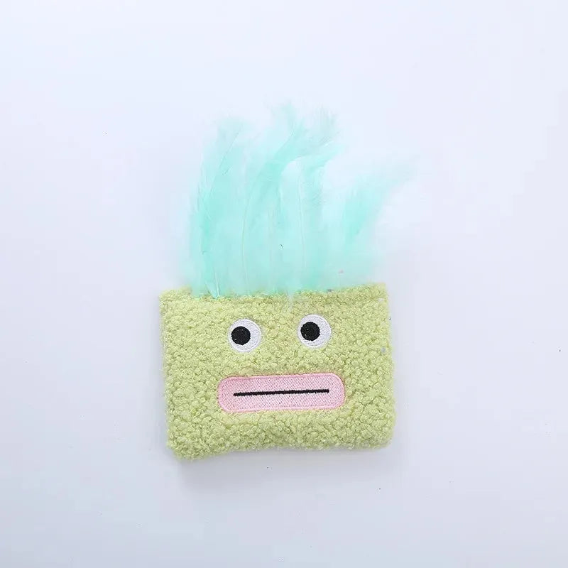 Colourful cat plush toy with a big mouth explosion head shape on a plain background.