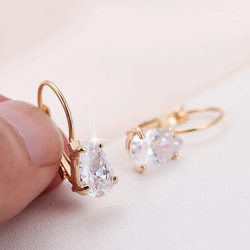 Drop-shaped metal earrings with platinum gem details in gold or platinum colour options