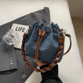 Blue one-shoulder cross body bucket bag with synthetic leather lining and hanging drop ornaments