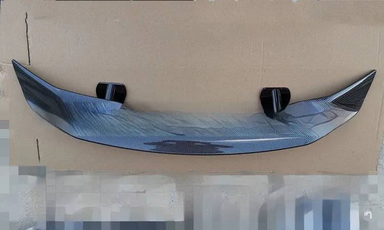 Punch-free adhesive mount car spoiler in ABS plastic, shown in carbon pattern finish.
