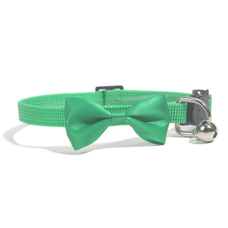 Adjustable nylon cat collar with decorative bow and bell in multiple colour options including red, blue, pink and green