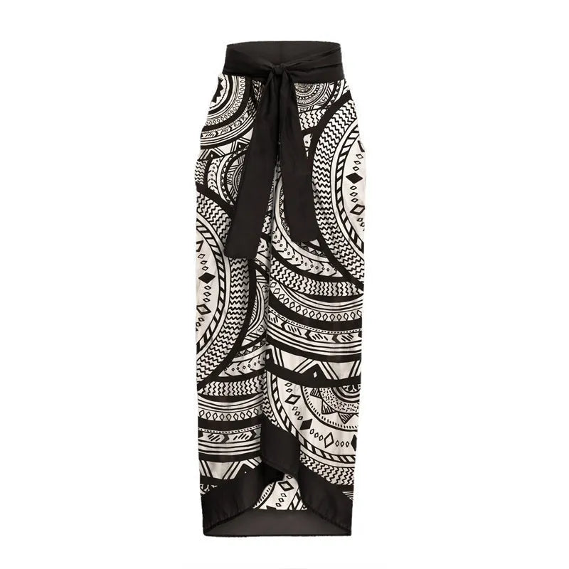 Women's vintage print one-piece swimsuit with deep V-neck and matching wrap skirt on a hanger.