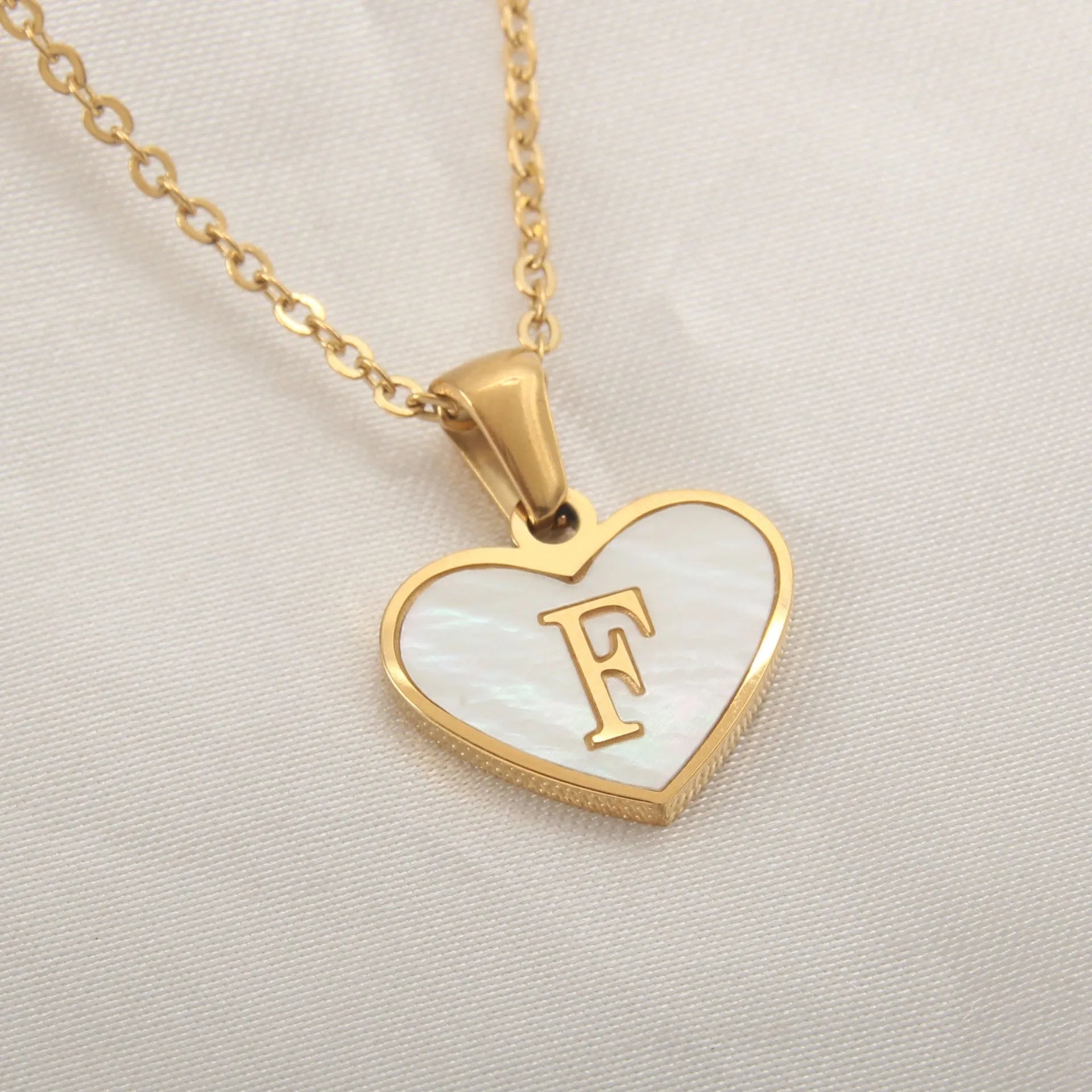 Gold plated heart-shaped necklace with white shell pendant on adjustable stainless steel chain