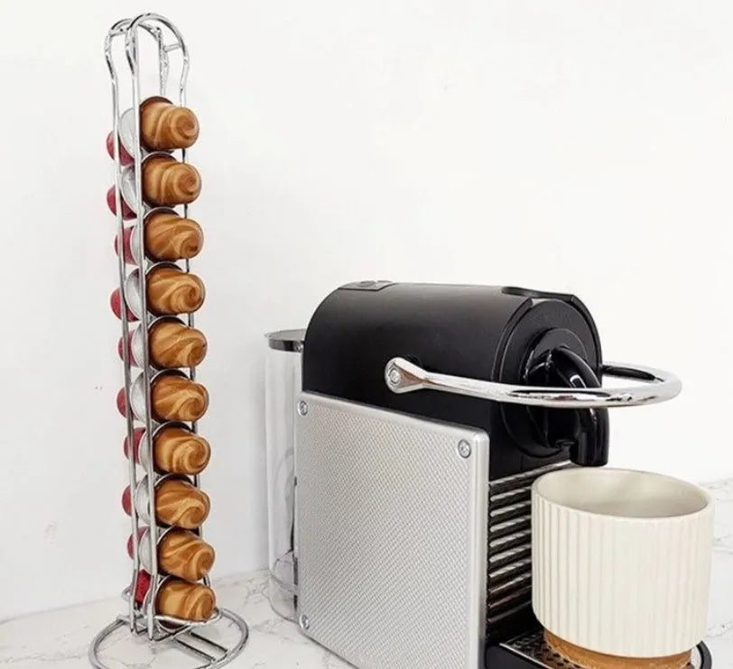Black iron coffee capsule storage rack holding multiple pods on display shelves.