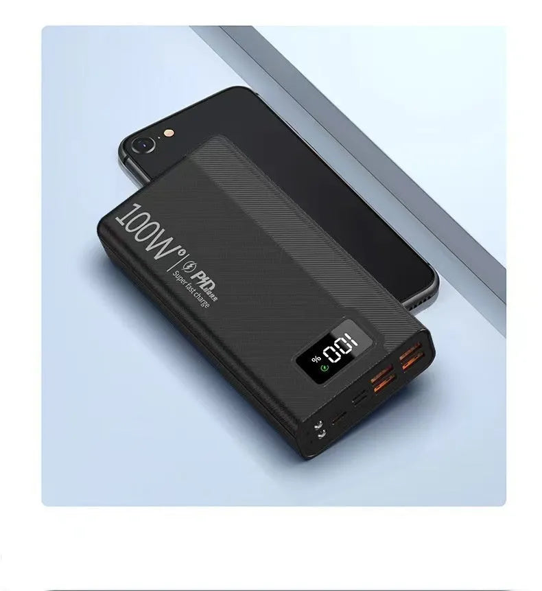 Large capacity black and white plastic power bank showing size relative to a smartphone.