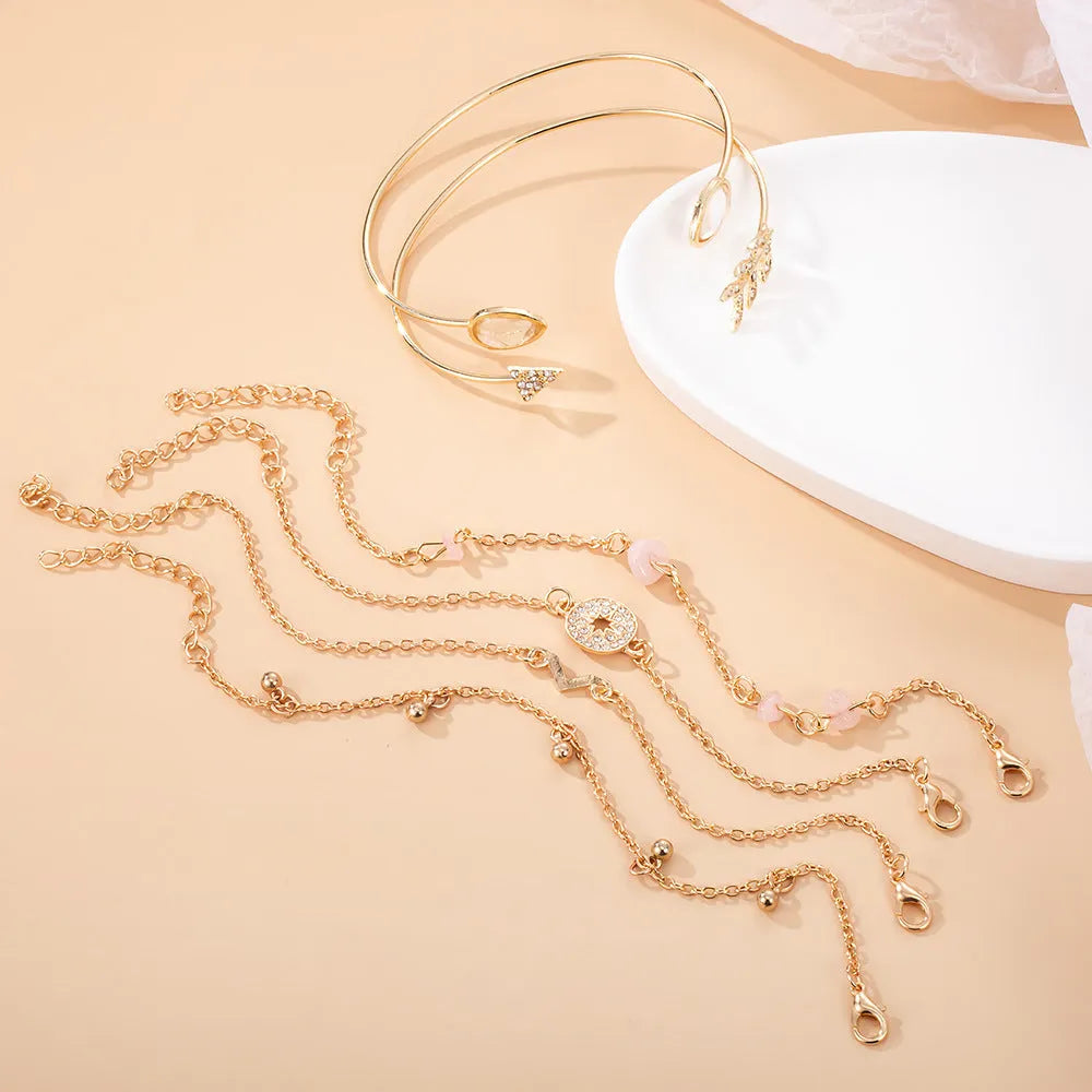 Six golden bracelets with spot drill, arrow, water drop and V-shaped pendants on zinc alloy chains