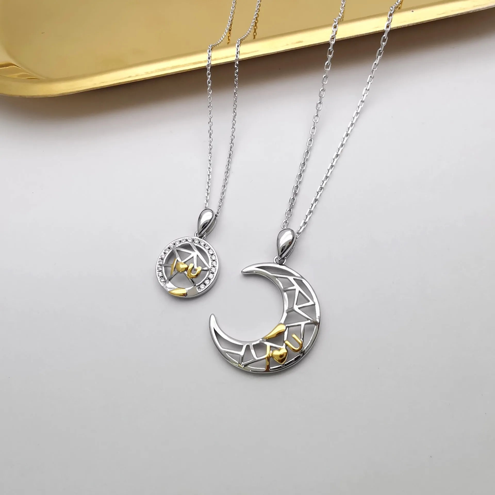 Sun and moon tooth couple necklace with copper pendant and cross chain.