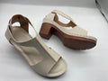 Women's peep toe wedge sandals with a buckle strap, shown in a light brown colour on a white background.