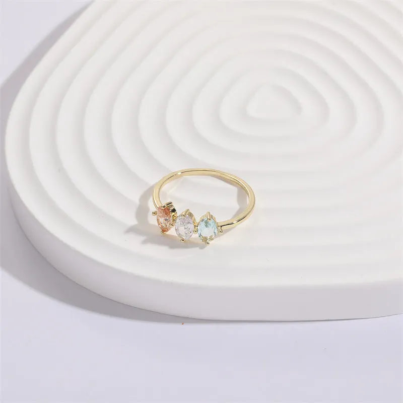 Gold electroplated geometric women's ring with triangular elements and horse eye tricolor zircon birthstone