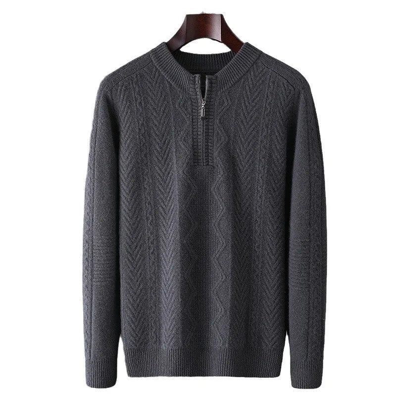 Man wearing a milky white half-zip wool sweater with a diamond pattern, showing loose fit and long sleeves.