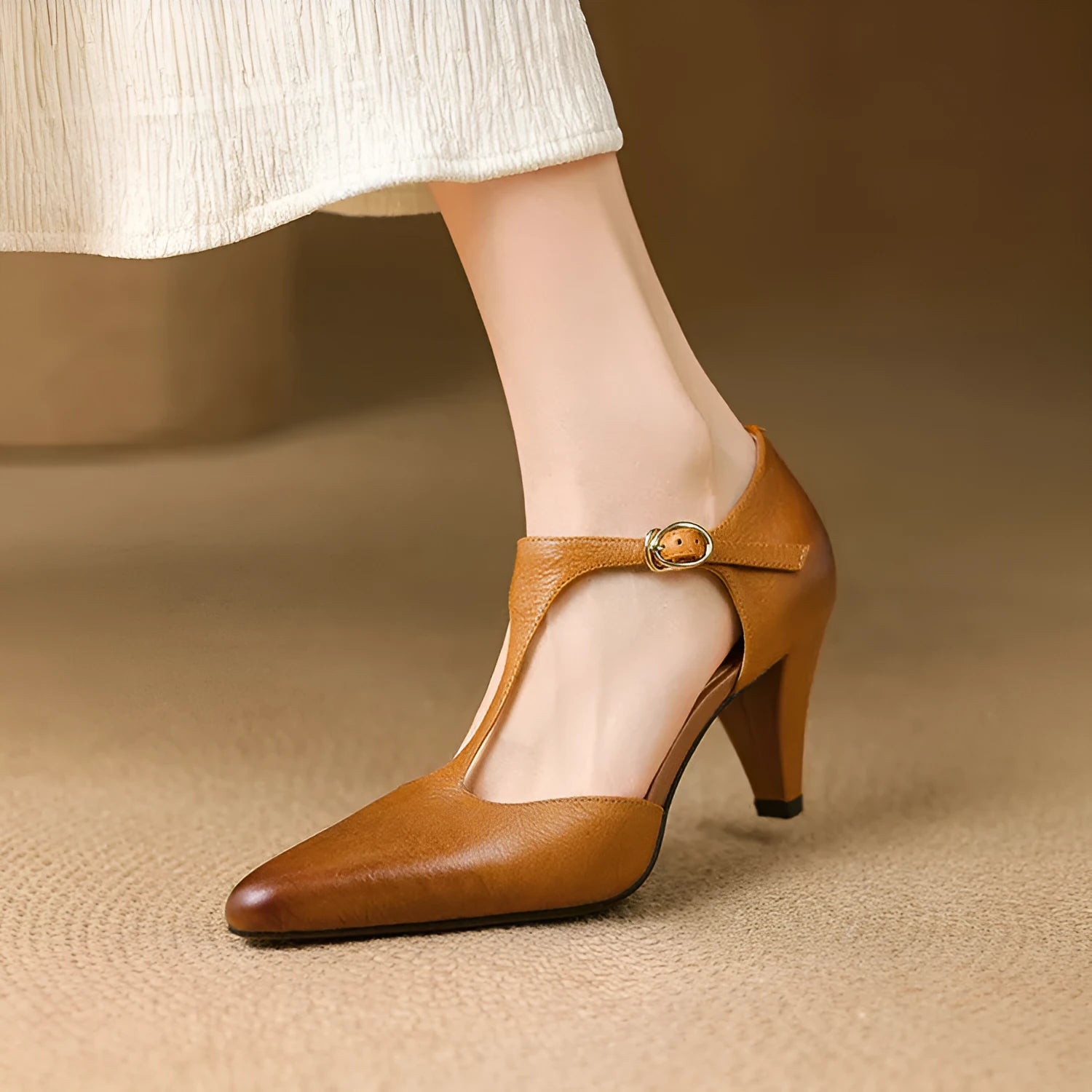 Women's brown retro T-strap closed toe sandals with a stout heel on a wooden surface