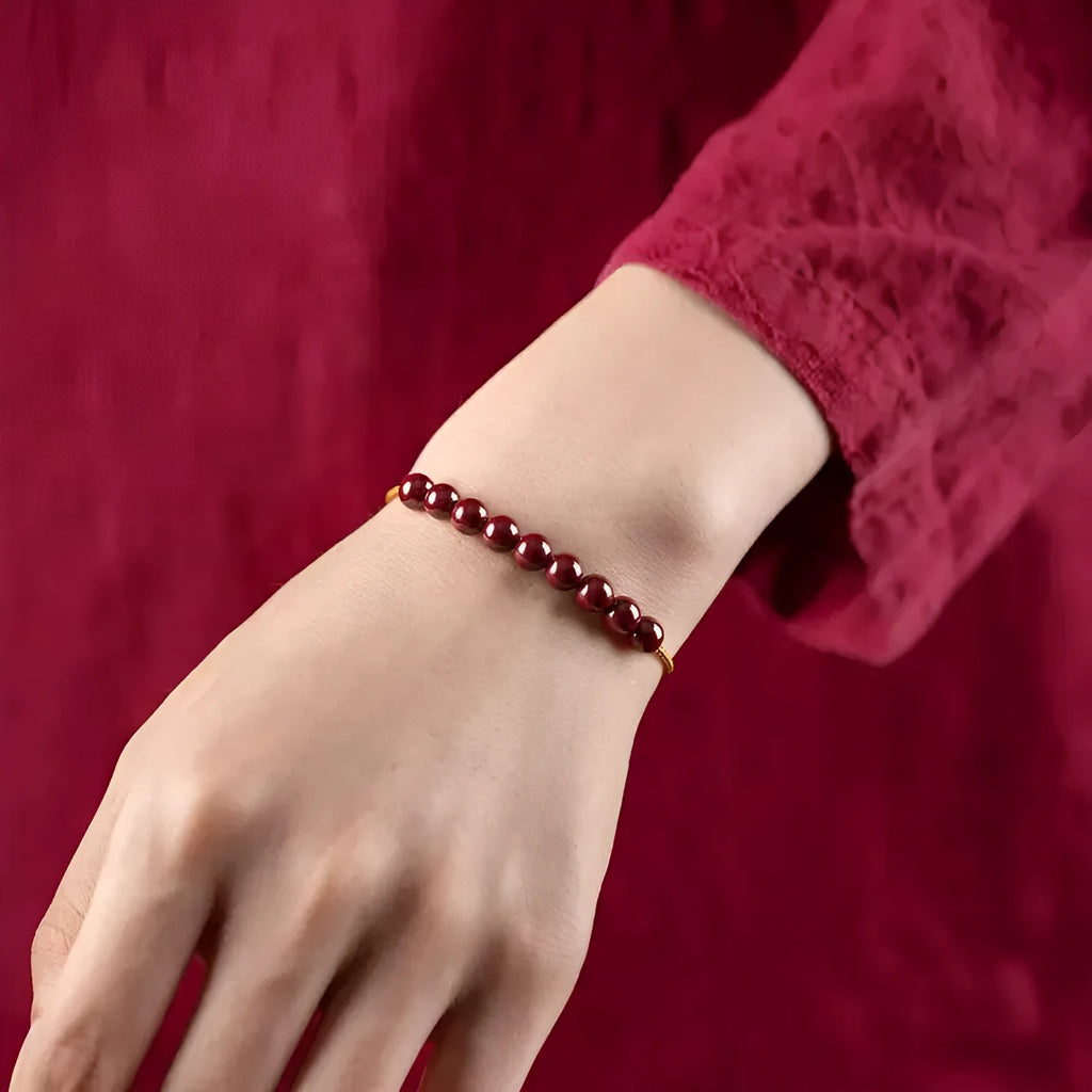 Hand-woven cinnabar geometric bracelet showing raw ore material texture and adjustable design