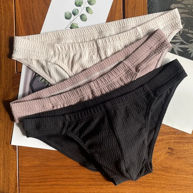 Men's solid colour cotton triangle underwear briefs in mid-waist design on a white background