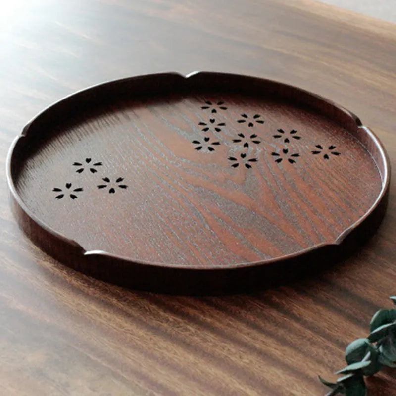 Wooden shallow serving plate with hollow cherry blossom design, 30 cm in diameter.