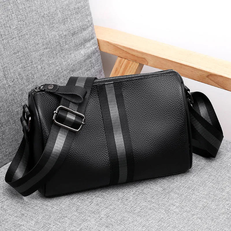 Black genuine leather one-shoulder crossbody bag showing front view and size.