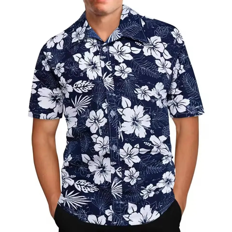 Man wearing a loose-fitting short-sleeve shirt with a colourful floral print pattern.