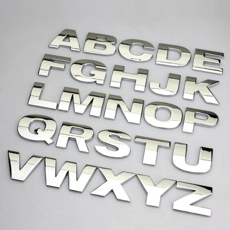 Close-up of a 3D metal zinc alloy letter 'A' car bumper sticker in silver finish.