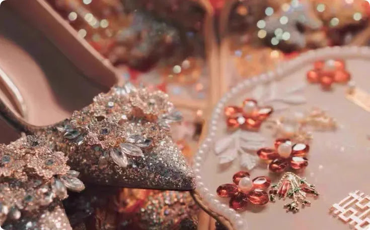 Champagne coloured bridal shoes with pointed toe, fine heel, and rhinestone floral decoration.