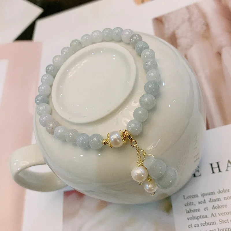 Chinese style jade bracelet with gourd design on woman's wrist