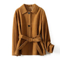 Women's mid-length art retro cashmere coat with Peter Pan collar and leather stitching in loose fit.