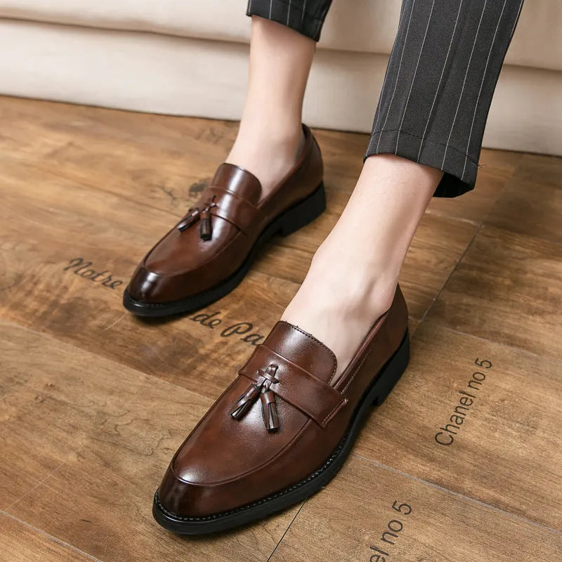 Men's black slip-on business shoes with tassel detail on artificial leather upper
