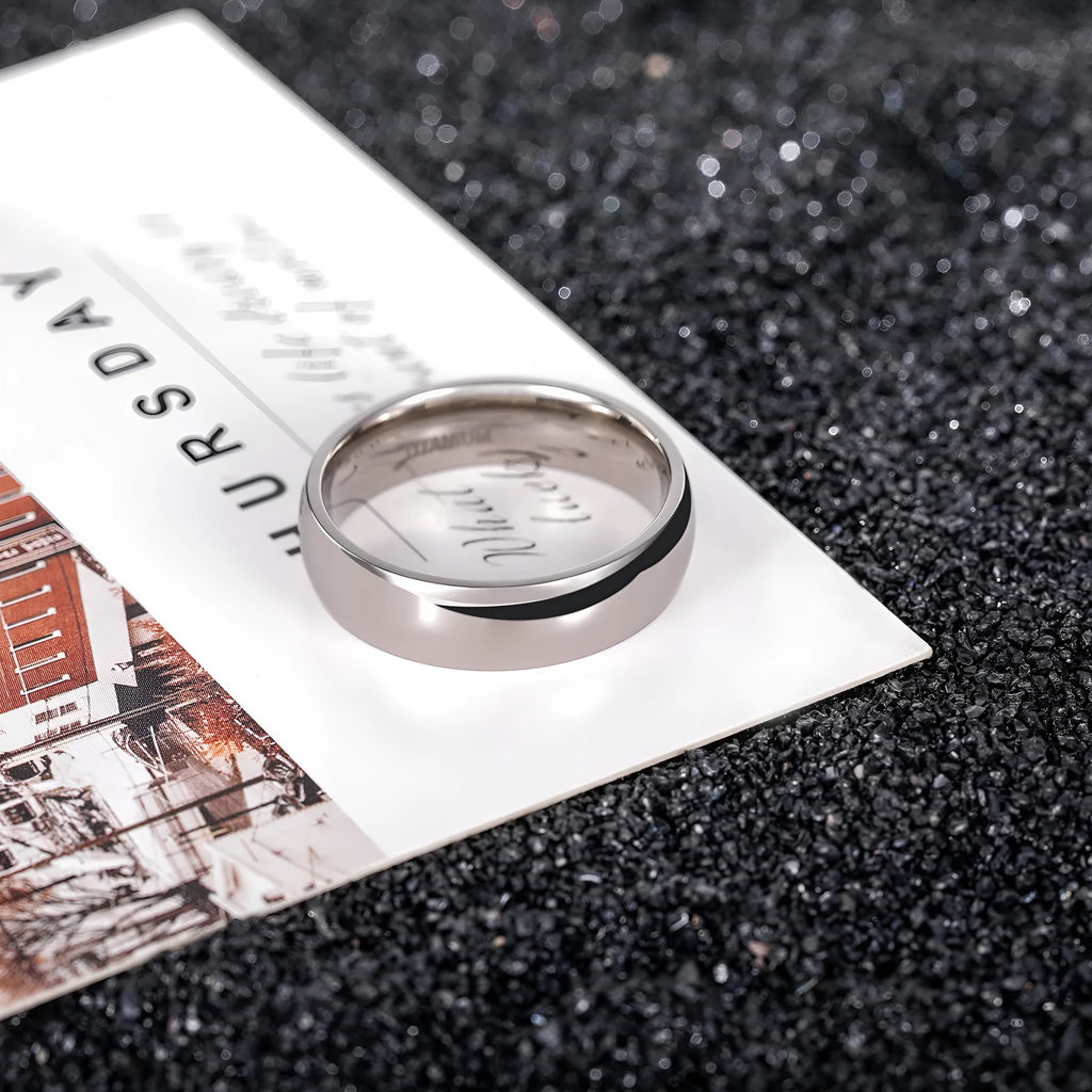 Silver titanium steel unisex ring shown in different band widths on a hand.