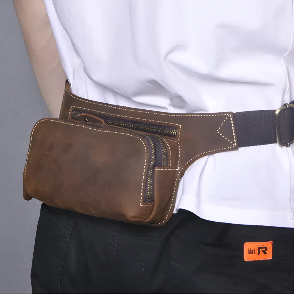 Brown top layer cowhide leather men's sports waist bag with pull-tab closure.