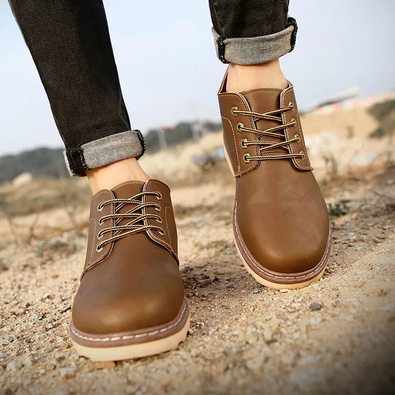 Men's black mid-top leather-style boots with rubber sole